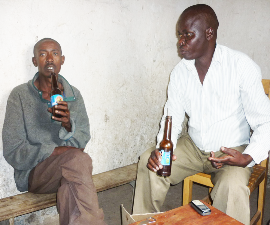 Uwihoreye on the left and Gakwerere on the right sharing beer at Gakwerere’s house.